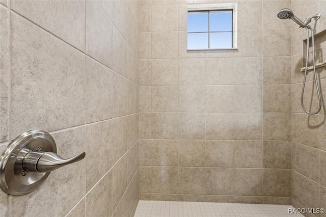 bathroom with tiled shower