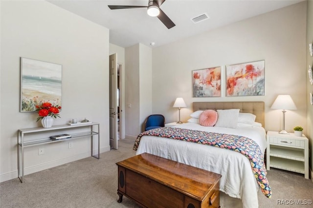 carpeted bedroom featuring ceiling fan, visible vents, and baseboards