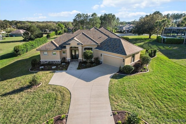 view of front of home with an attached garage, driveway, a tiled roof, stucco siding, and a front lawn