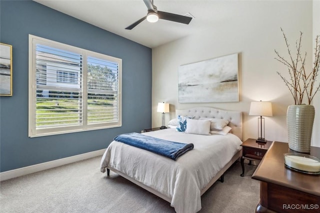 carpeted bedroom featuring baseboards and a ceiling fan