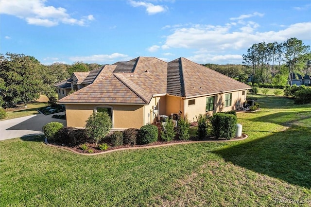 view of home's exterior with a lawn and stucco siding