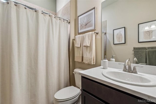 full bathroom featuring toilet and vanity