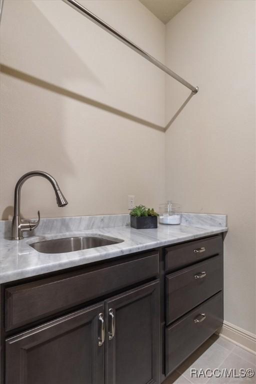 interior space with a sink and baseboards