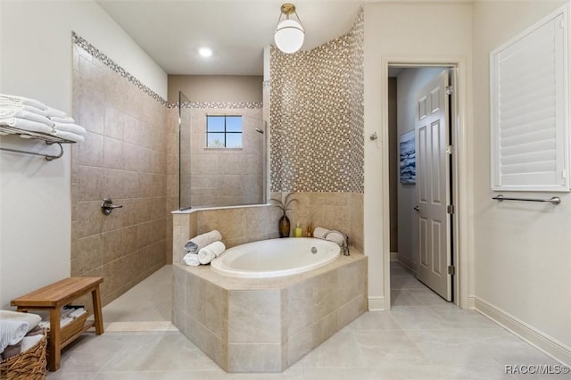 full bathroom with a walk in shower, tile patterned flooring, a bath, and baseboards