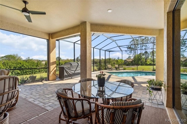 sunroom / solarium featuring ceiling fan