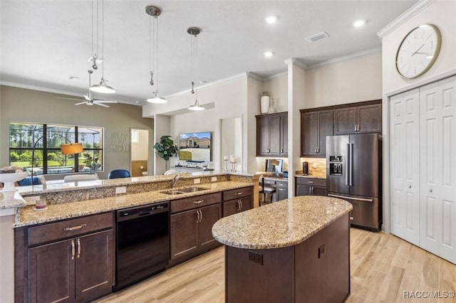 kitchen with a kitchen island with sink, a sink, visible vents, high end fridge, and dishwasher