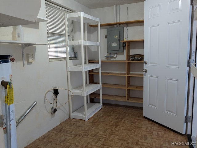 storage room featuring electric panel and gas water heater