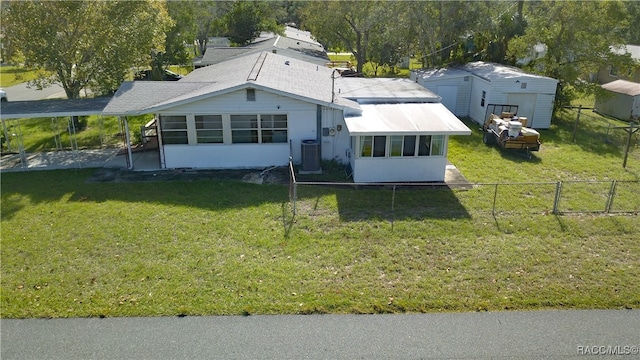 back of property featuring a lawn, a sunroom, and central AC unit