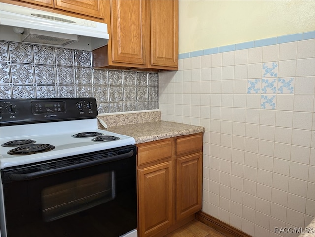 kitchen with tile walls and electric stove