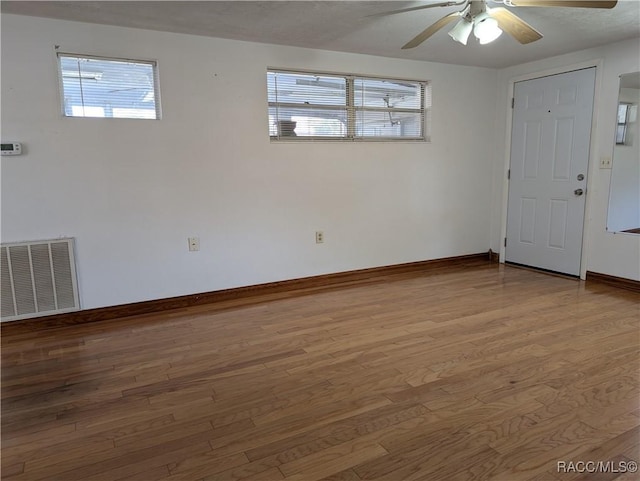 spare room with hardwood / wood-style floors and ceiling fan