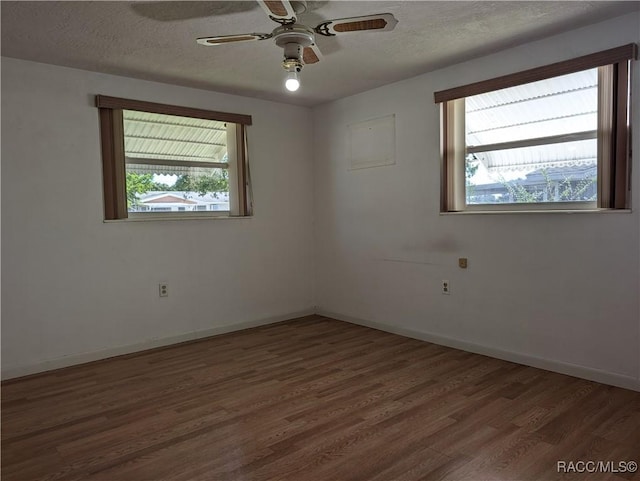 2 Plaza St, Beverly Hills, FL 34465 - spare room with wood finished floors, ceiling fan, and a textured ceiling