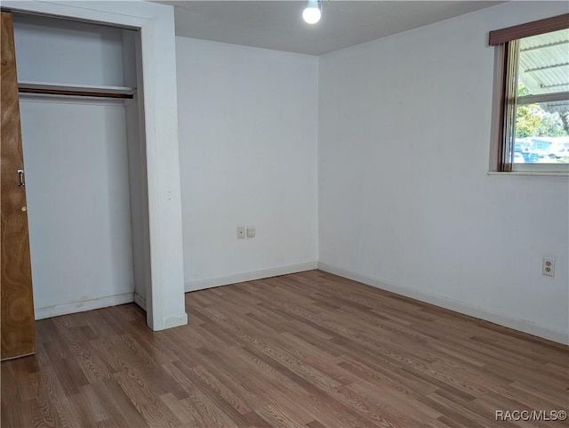 2 Plaza St, Beverly Hills, FL 34465 - unfurnished bedroom with wood finished floors and a closet
