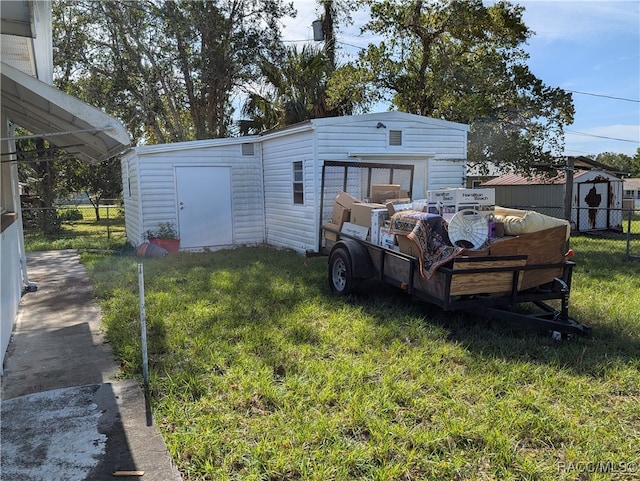 exterior space featuring an outdoor structure and a yard