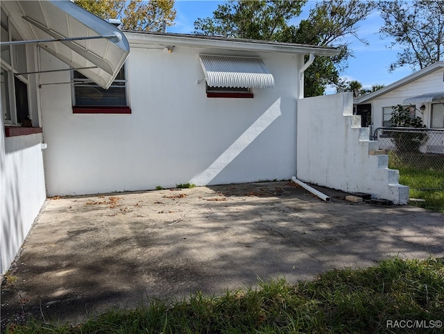 view of side of property with a patio area