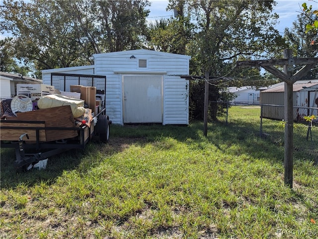 view of outbuilding with a yard