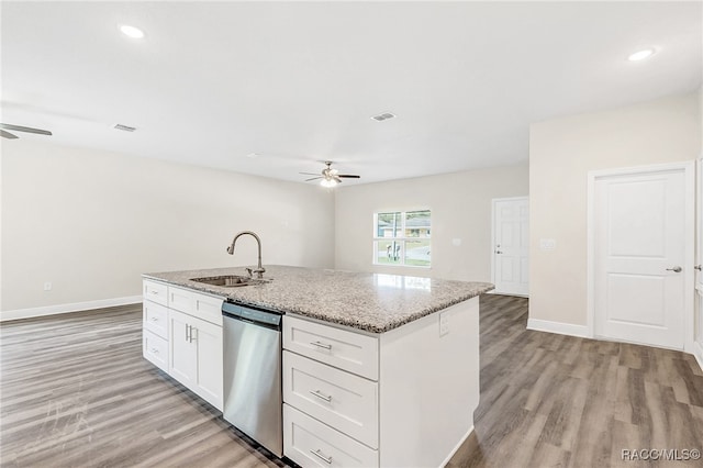 kitchen featuring sink, stainless steel dishwasher, an island with sink, light hardwood / wood-style floors, and white cabinets