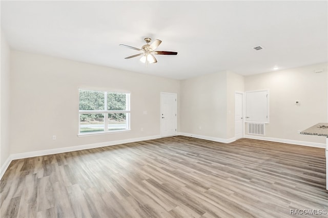 unfurnished living room with light hardwood / wood-style flooring and ceiling fan