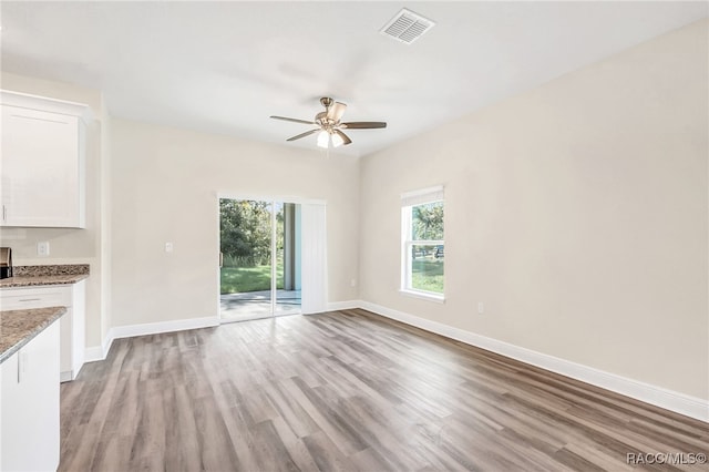 unfurnished living room featuring light hardwood / wood-style floors and ceiling fan