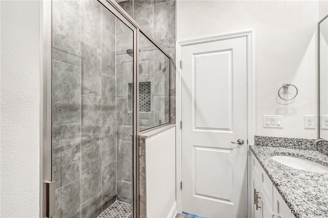 bathroom with vanity and an enclosed shower