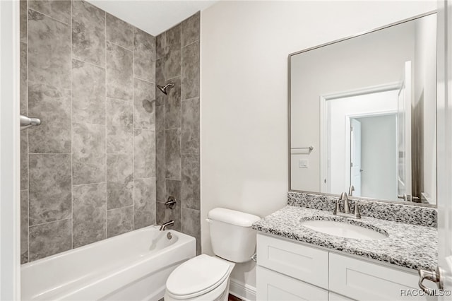 full bathroom with vanity, toilet, and tiled shower / bath