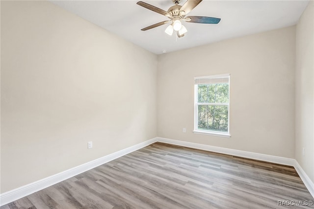 empty room featuring light wood-type flooring and ceiling fan