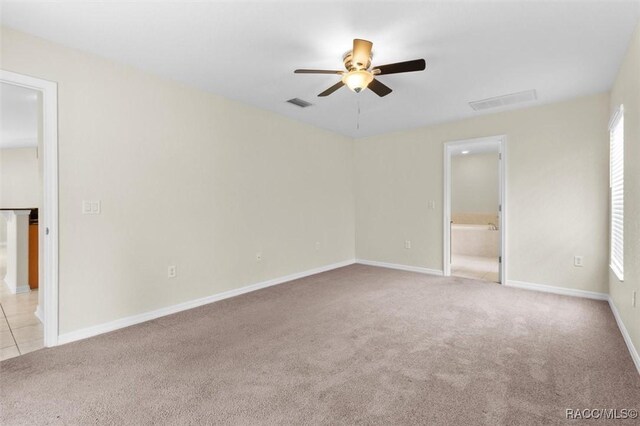 empty room with ceiling fan and carpet floors