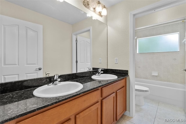 full bathroom featuring vanity, tiled shower / bath, tile patterned floors, and toilet