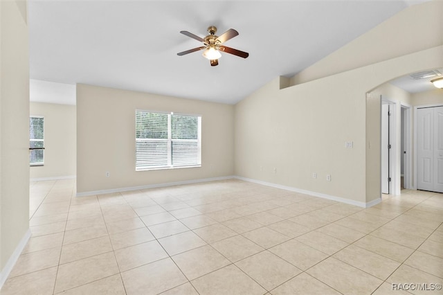 spare room featuring light tile patterned floors, ceiling fan, and lofted ceiling