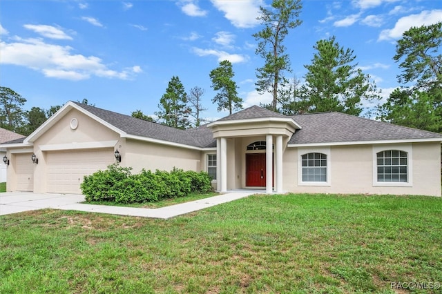 single story home featuring a garage and a front lawn