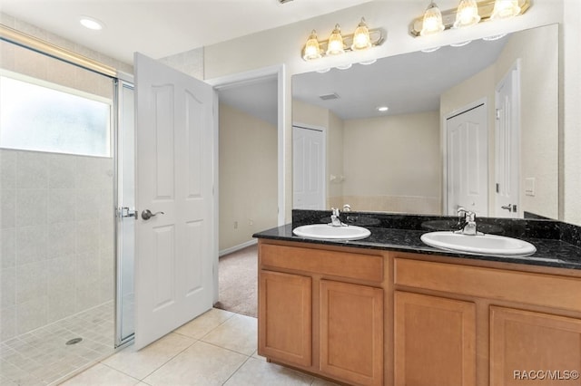 bathroom featuring vanity, tile patterned floors, and walk in shower