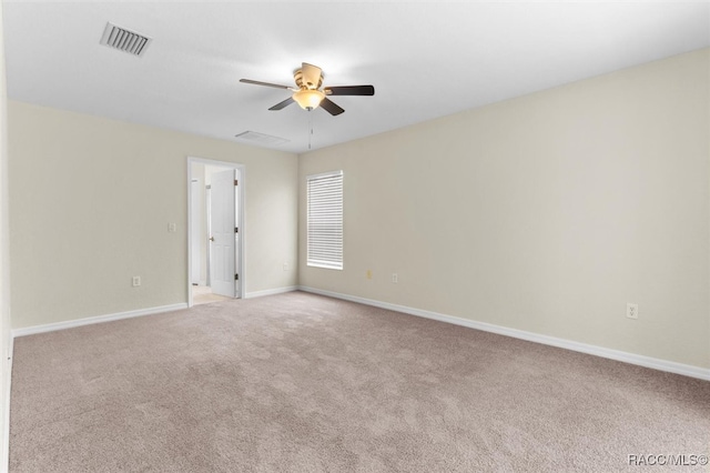 carpeted spare room with ceiling fan