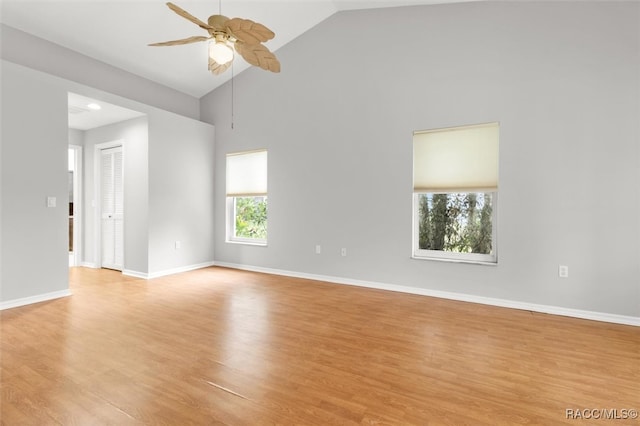 empty room with light hardwood / wood-style floors, high vaulted ceiling, and ceiling fan