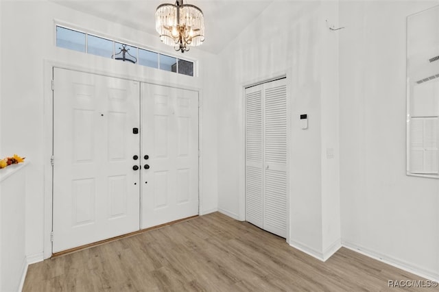 entryway featuring a notable chandelier and light wood-type flooring