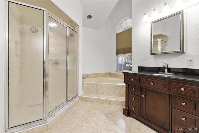 bathroom featuring vanity, tile patterned flooring, plus walk in shower, and vaulted ceiling