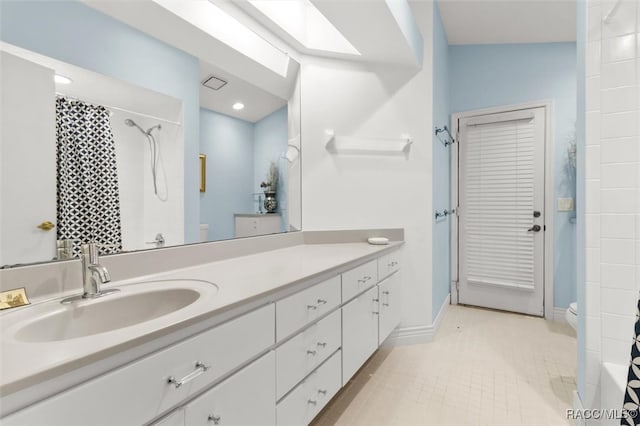 bathroom with tile patterned flooring, vanity, toilet, and a tile shower