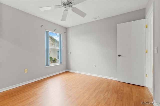 spare room featuring ceiling fan and light hardwood / wood-style flooring