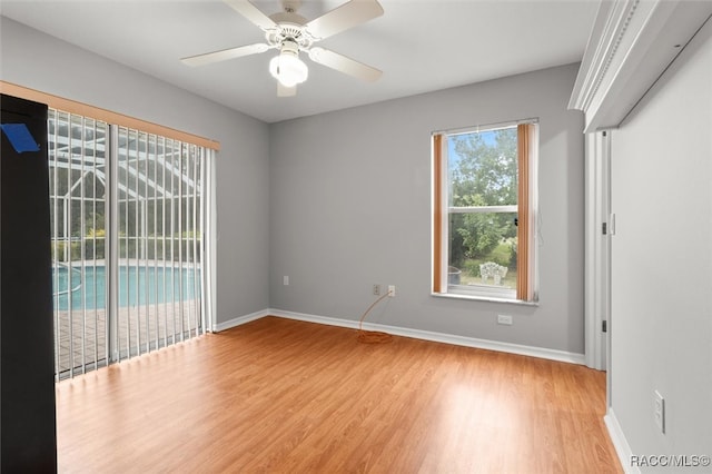 empty room with ceiling fan and light hardwood / wood-style flooring