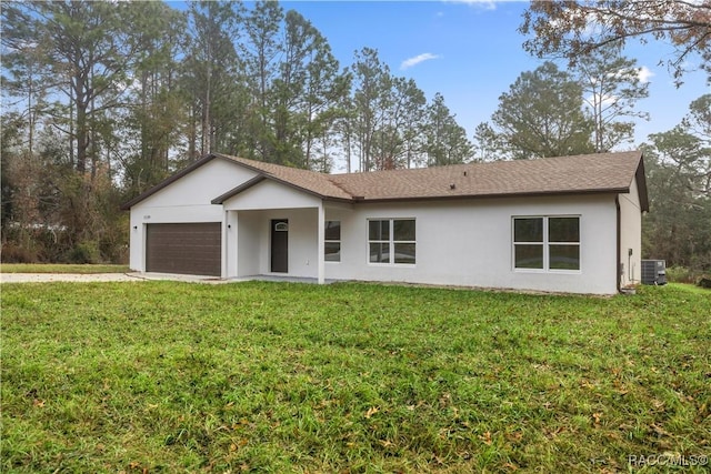 ranch-style home featuring central air condition unit, a front lawn, and a garage