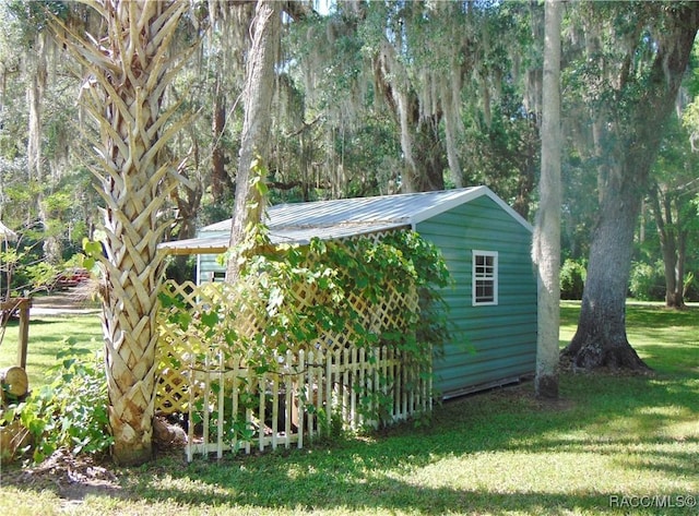 view of outbuilding featuring a lawn