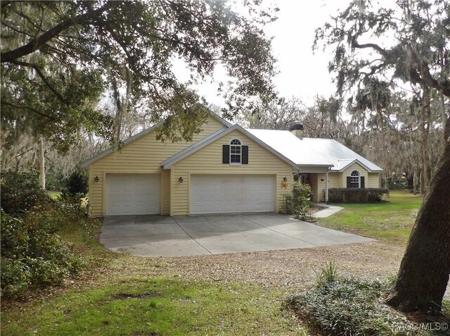 ranch-style house with a porch, a front lawn, and a garage