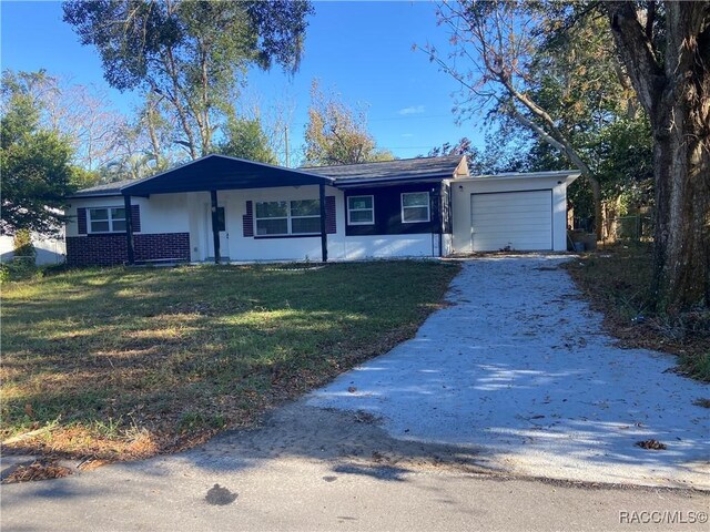 11 S Tyler St, Beverly Hills, FL 34465 - ranch-style house featuring a garage, driveway, and a front lawn