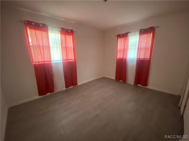 spare room with hardwood / wood-style flooring