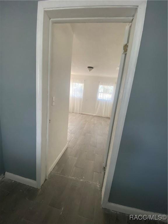 hallway with hardwood / wood-style floors