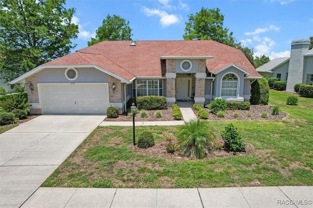 6150 N Whispering Oak Loop, Beverly Hills, FL 34465 - mediterranean / spanish-style house with brick siding, an attached garage, a front lawn, driveway, and roof with shingles