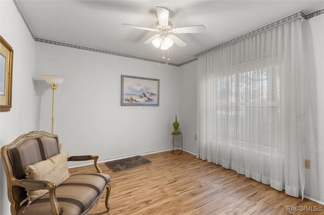 6150 N Whispering Oak Loop, Beverly Hills, FL 34465 - sitting room with ceiling fan, light wood-style flooring, and baseboards