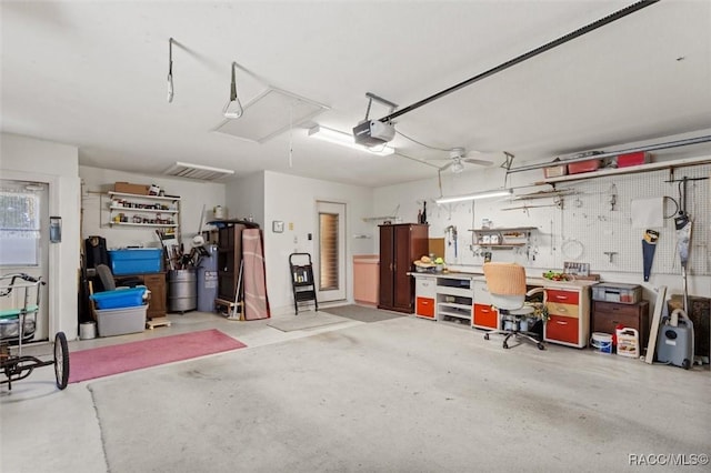 6150 N Whispering Oak Loop, Beverly Hills, FL 34465 - garage with a workshop area and a garage door opener