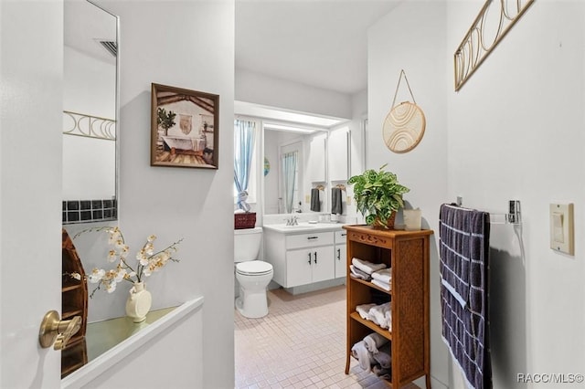 6150 N Whispering Oak Loop, Beverly Hills, FL 34465 - bathroom with vanity, toilet, and tile patterned flooring