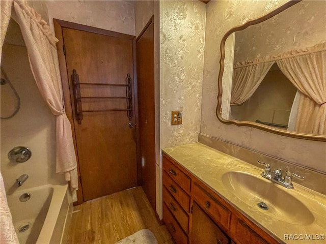 bathroom with vanity, hardwood / wood-style flooring, and shower / bath combo