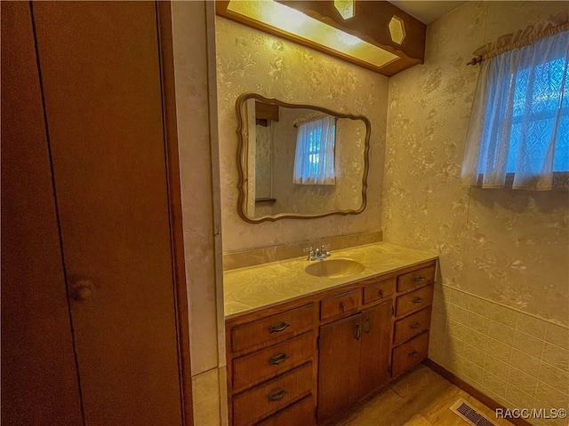 bathroom featuring hardwood / wood-style flooring and vanity