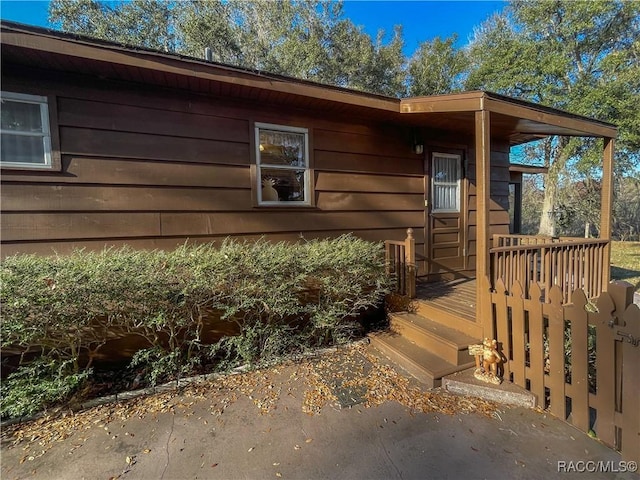 view of exterior entry with a deck